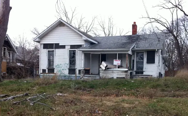 A boarded-up house with an unkempt yard in Allen Park, MI & Center Line, MI