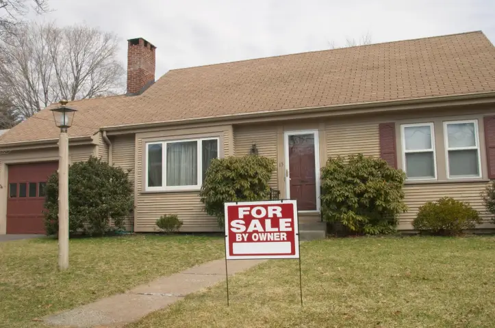 A house is displayed with a for sale sign in the foreground in Allen Park, MI.